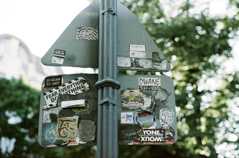 an assortment of stickers on the side of a pole