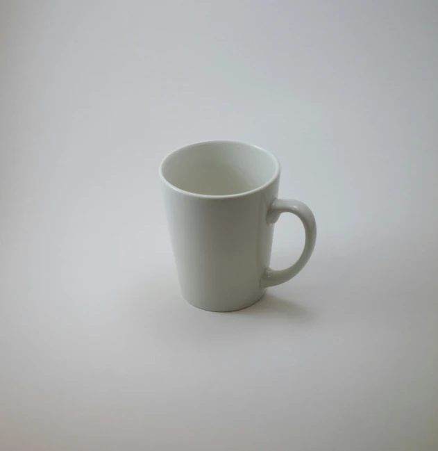 a white coffee cup with handles and a dark colored rim