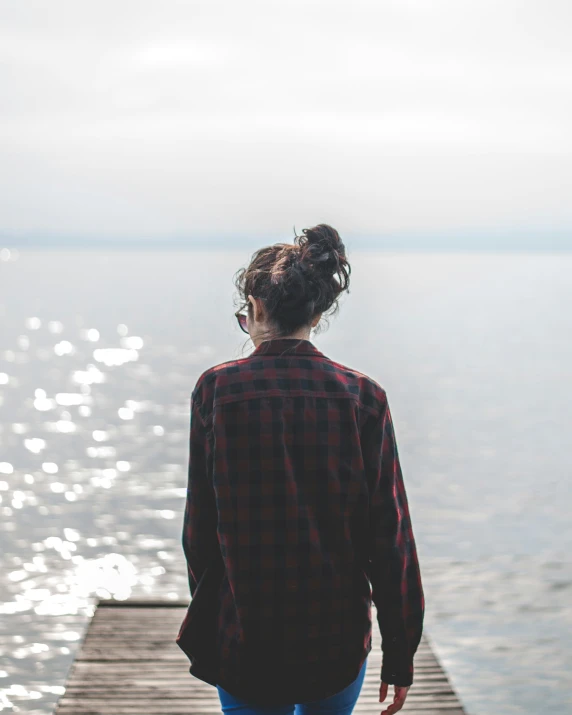 a person looking out over water on a dock