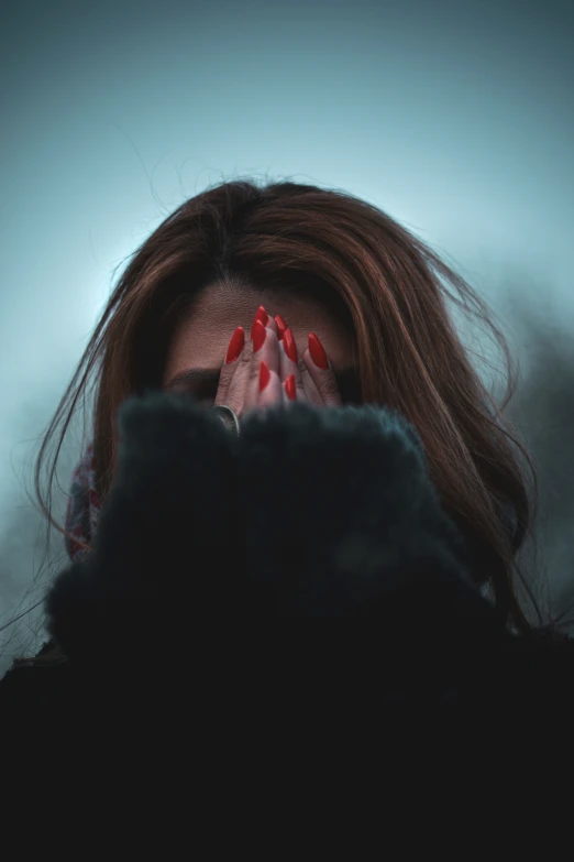 a woman covers her face with her hands