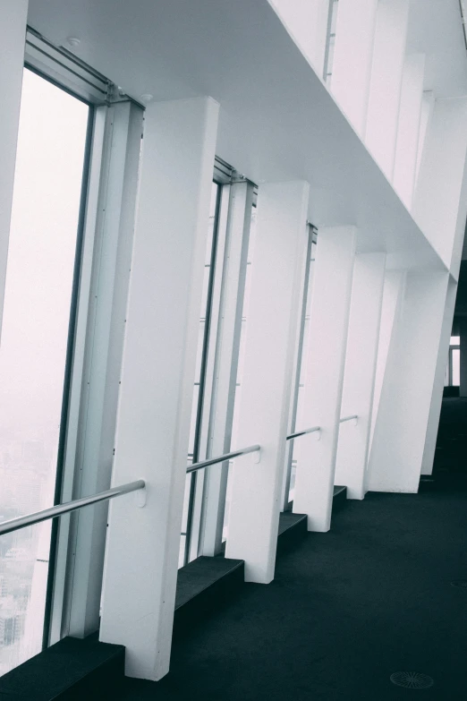 an abstract pograph of a white staircase with glass railings and balconies