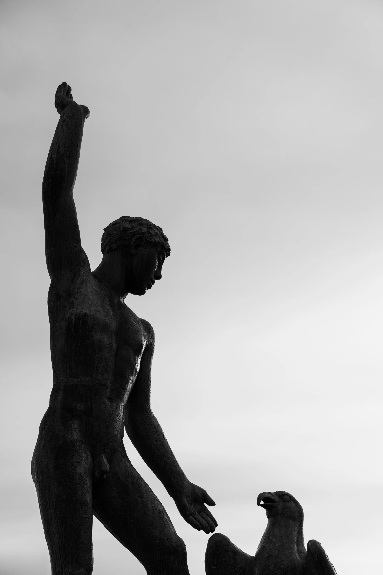 the statue shows a woman holding a bird in her hand