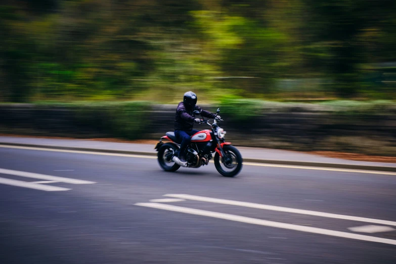 a man is riding a motorcycle down the road