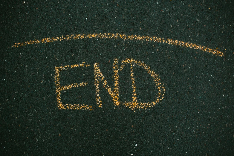 a black surface with an end written in bright yellow and yellow lines