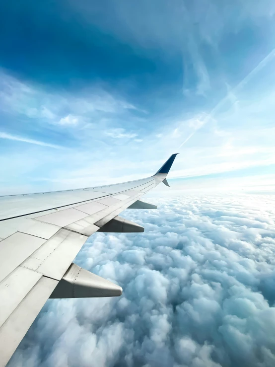 a jet flying through the sky above some clouds