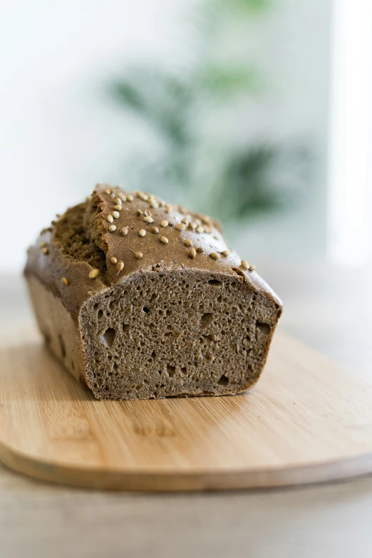 a loaf of bread is sitting on top of a wooden  board