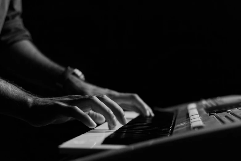 a man with his hands on a keyboard