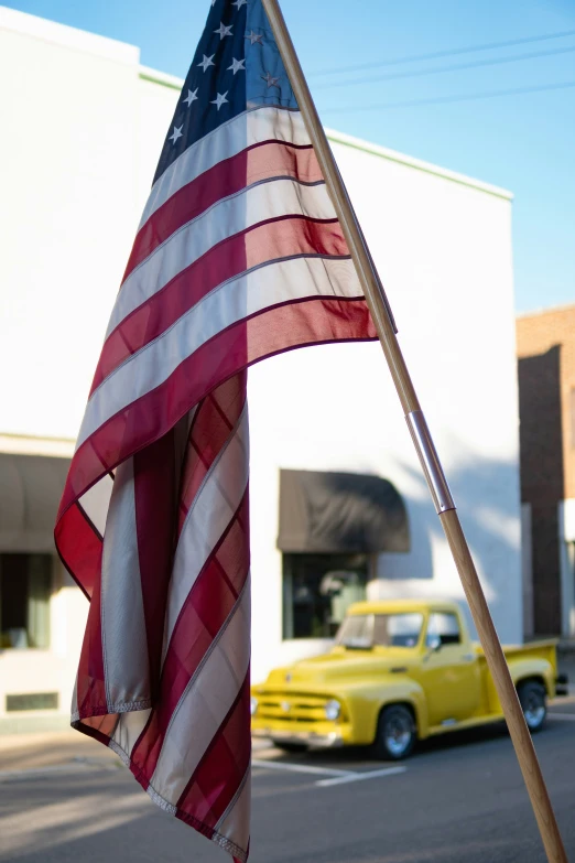 an american flag hanging in a street corner