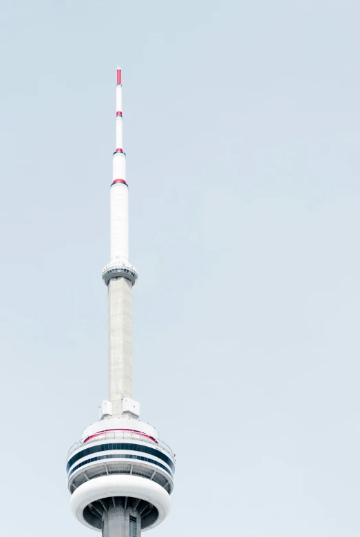 a large tower structure with an airplane at the top