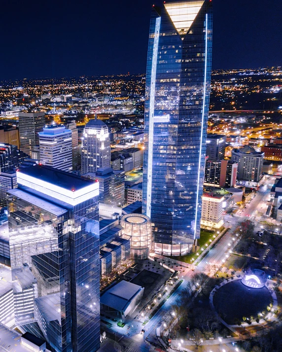 a high - rise city building is lit up at night