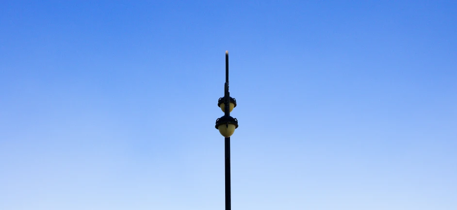 an elegant lamp post in front of blue sky