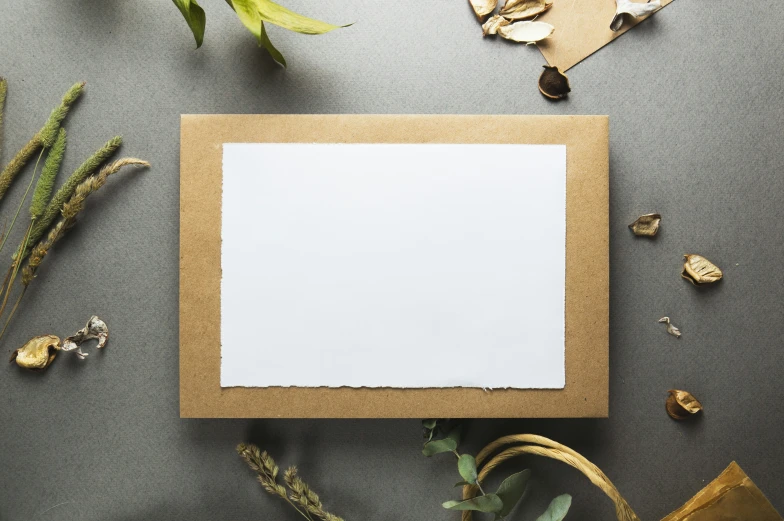 a blank paper sits upon a cardboard with a wooden box