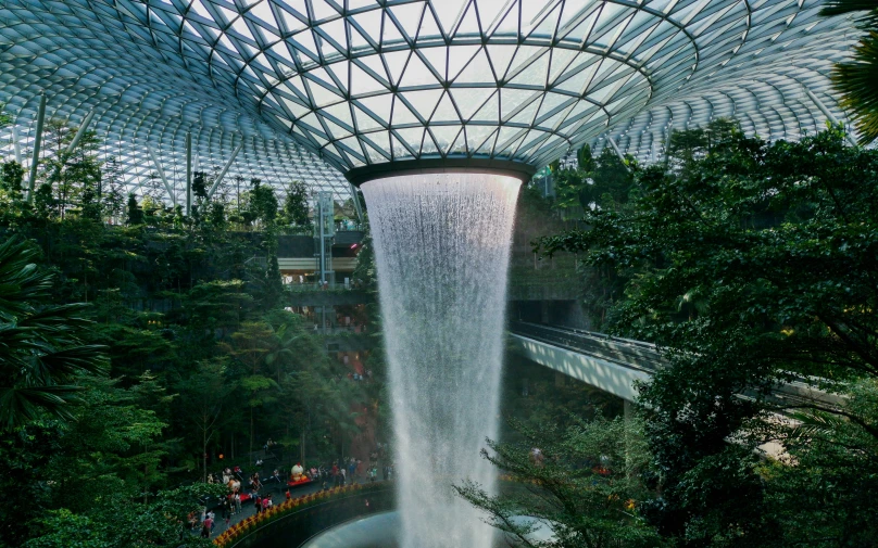 a waterfall with people walking inside of it