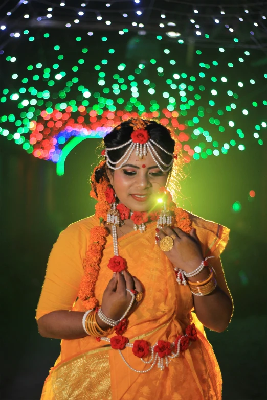 woman dressed in yellow doing a religious cultural trick