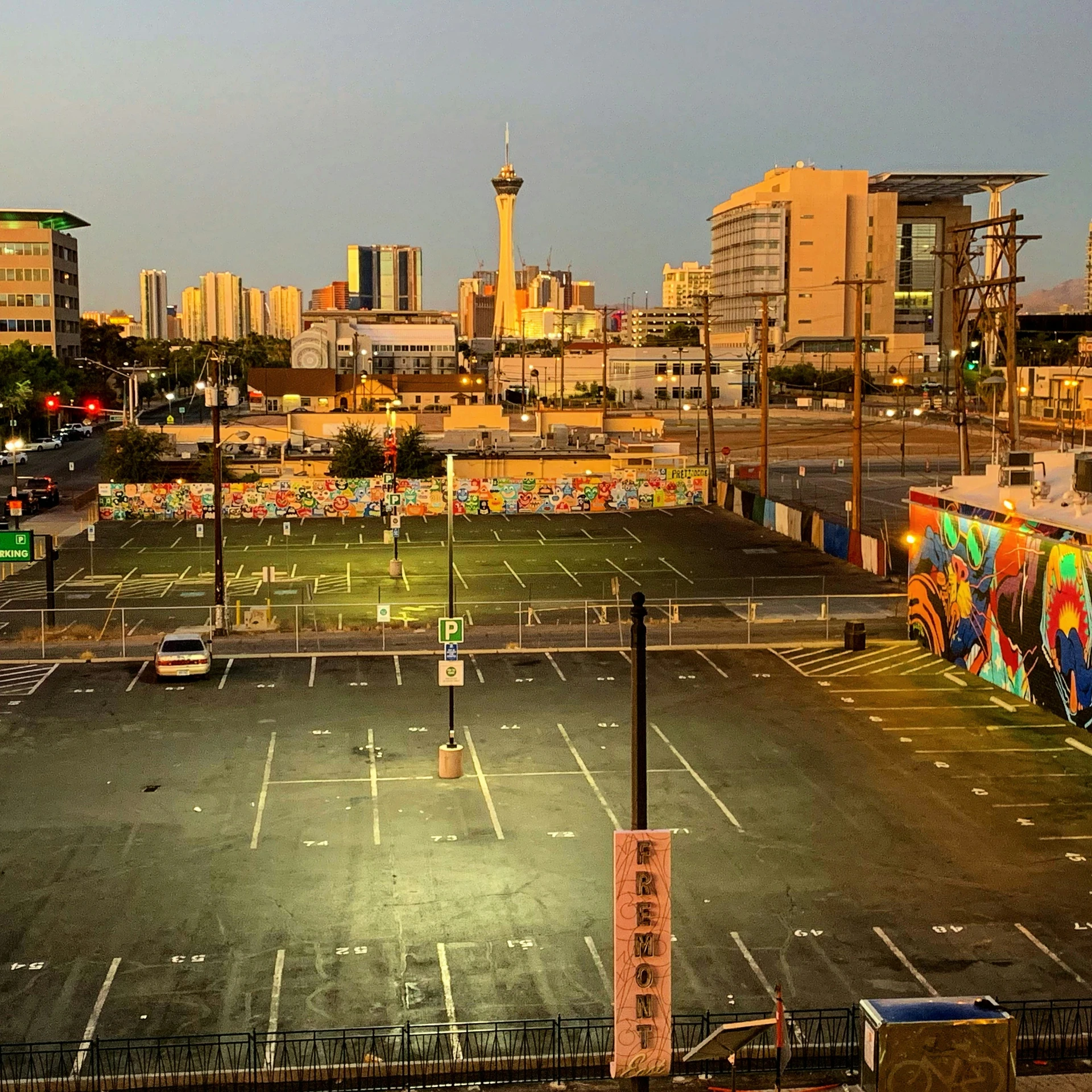 an empty parking lot in front of the city