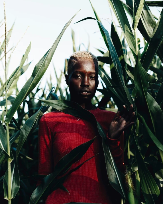 a man is standing in the middle of a field with grass