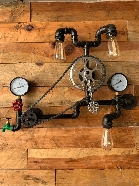 there is a steam engine and two light bulbs mounted to the wall