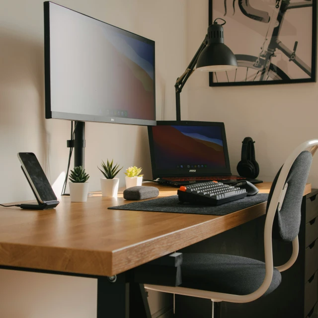 a corner desk with a computer and chair