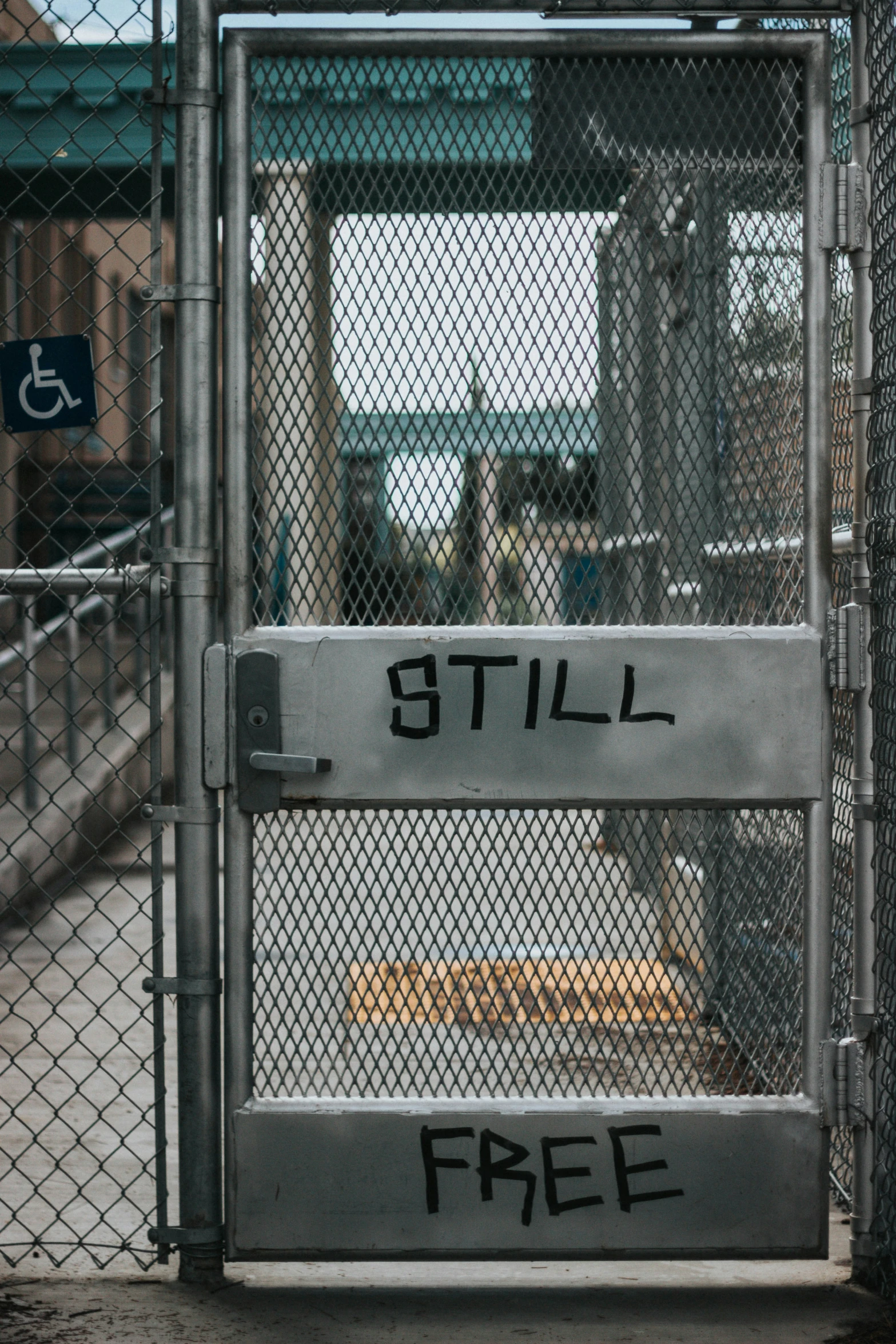 the gate is locked and has graffiti on it