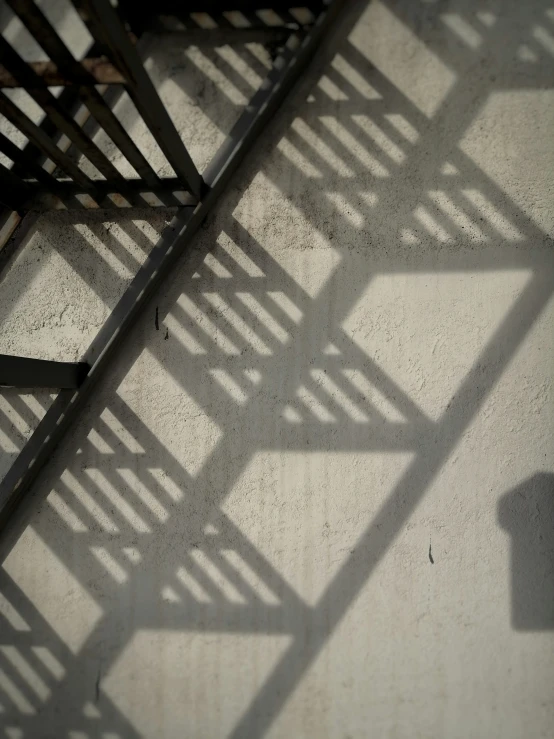 a shadow of a chair with a table below it