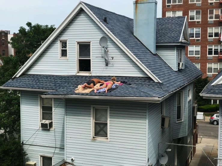 two people laying on top of the roof