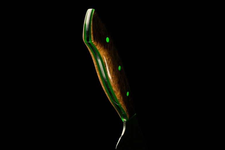 a green toothbrush has been placed in the dark