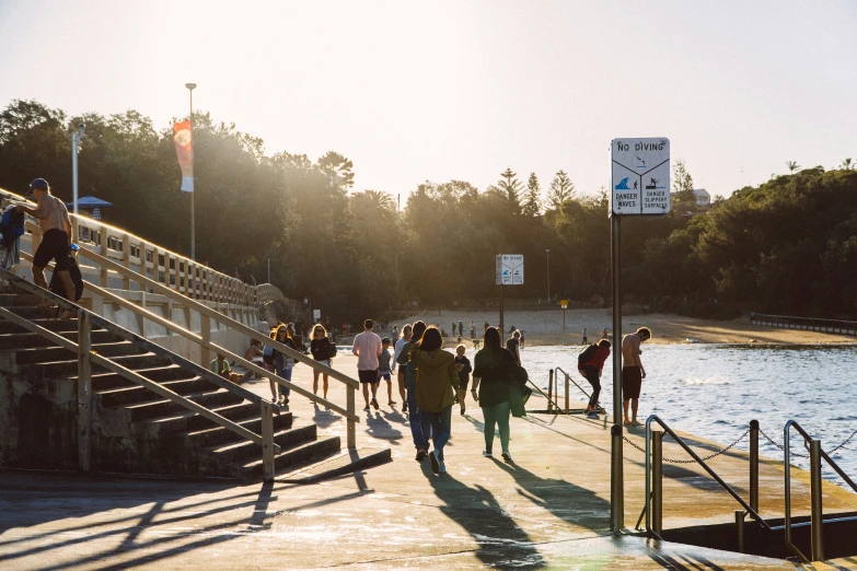 a group of people that are walking on some kind of pier