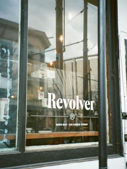an old fashioned storefront window with an advertit for revolver