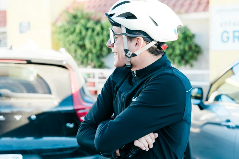 a man in black jacket and white helmet smiling