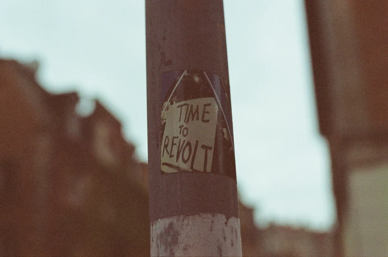 a sign on a pole near some buildings