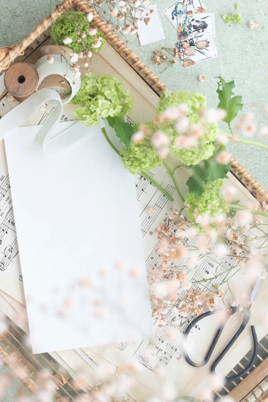 green broccoli is in a decorative basket next to an empty note pad