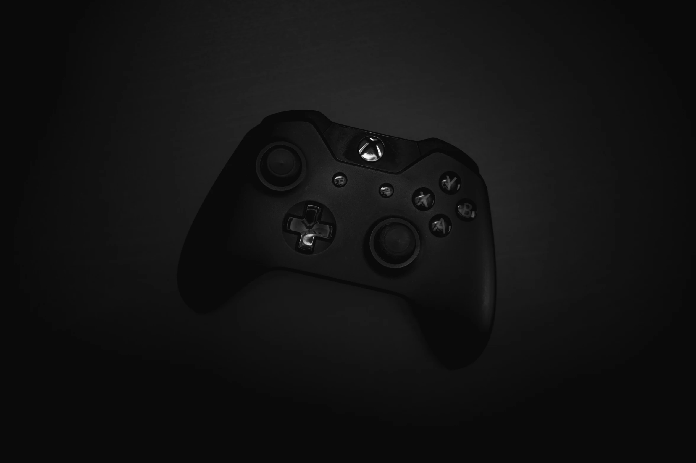 a black controller in a dark background