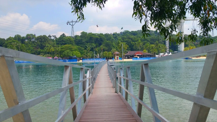 a very long wooden bridge is over the water