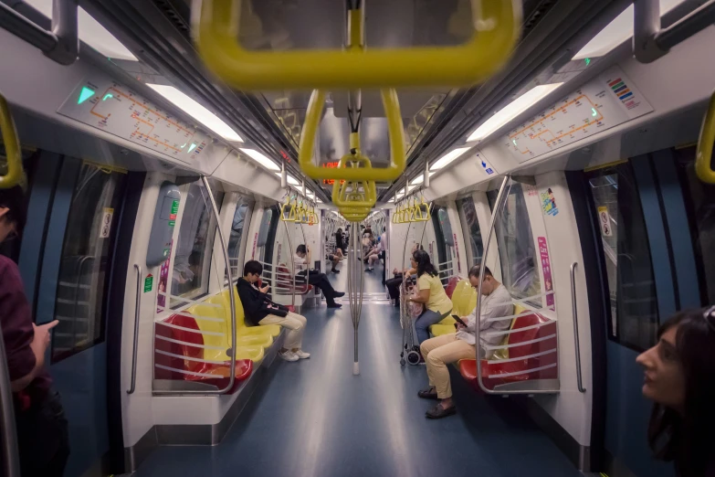 people are sitting and standing on the train