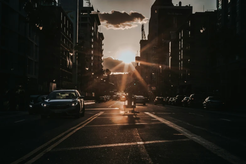 cars and motorcycles traveling down an empty road