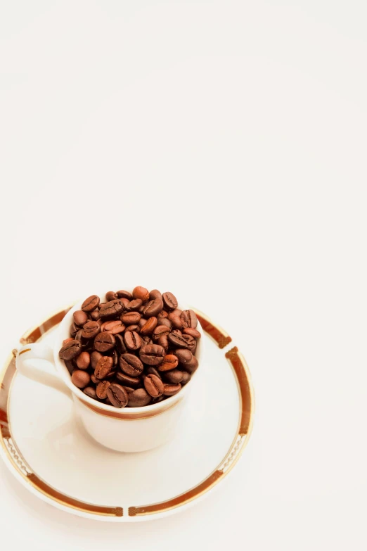 a close up of a cup on a saucer filled with roasted coffee