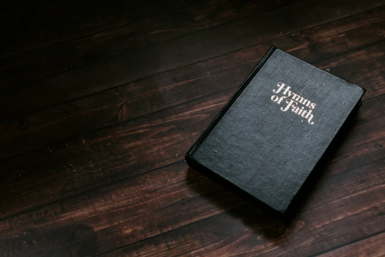 the front of a hardback journal on a wood table