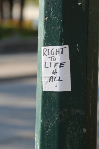 a sticker sitting on the corner of a pole