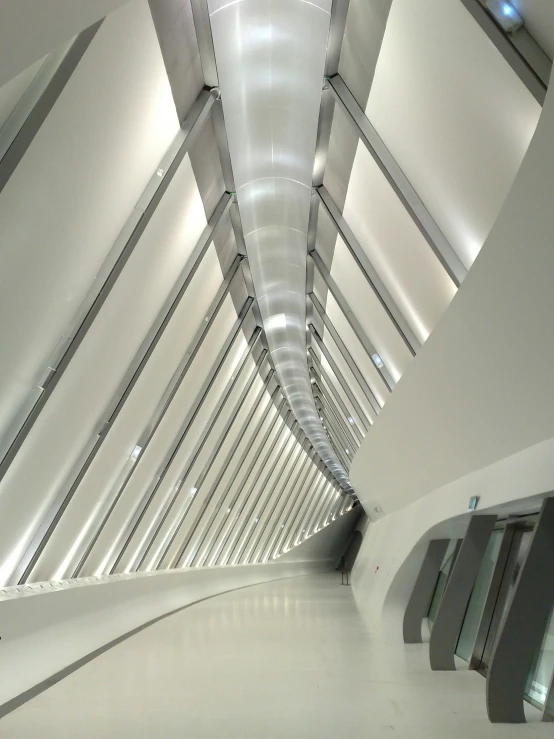 an empty room with a ceiling made of metal beams