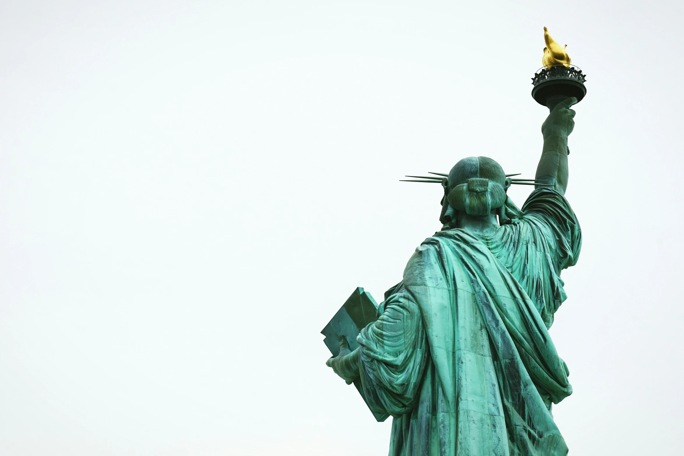 the statue of liberty is holding a cup of tea