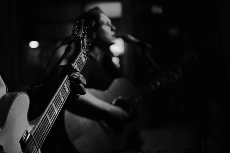 someone playing an acoustic guitar on a stage