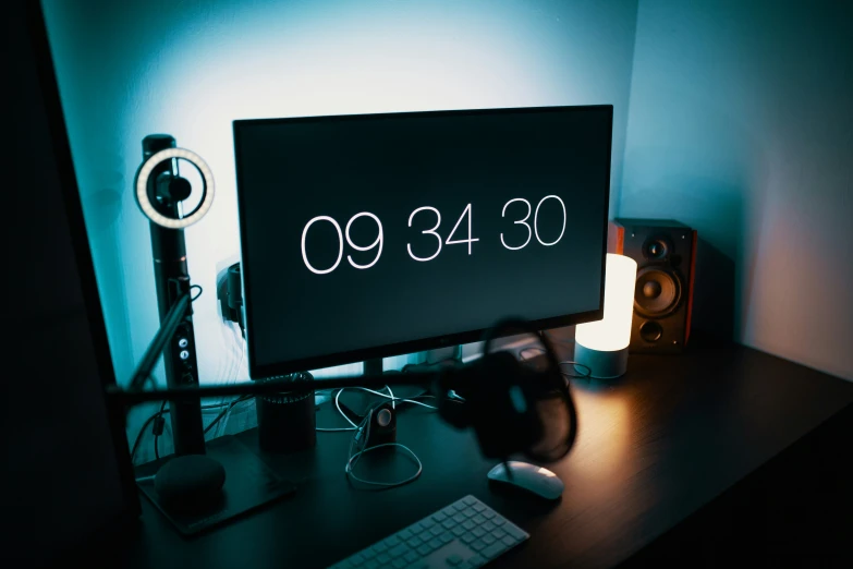 a computer monitor on a desk with speakers