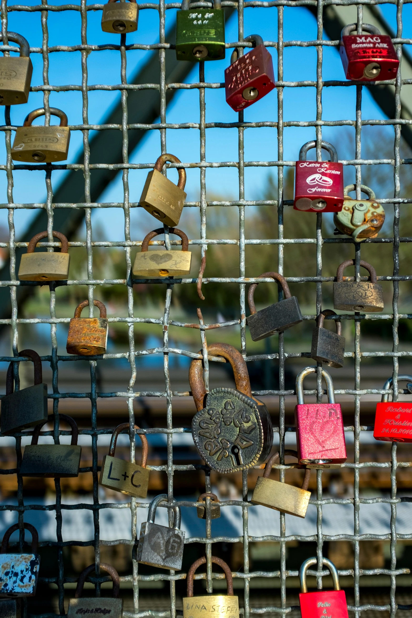 many padlocks are attached to the fence