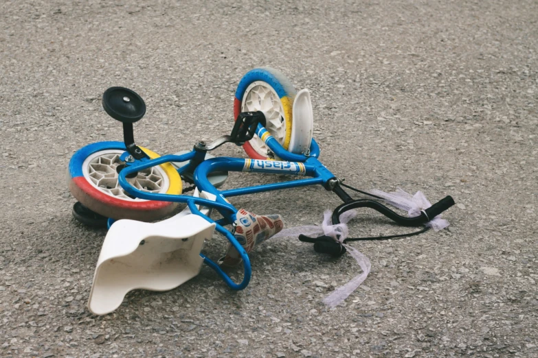 a broken toy car lying on a road