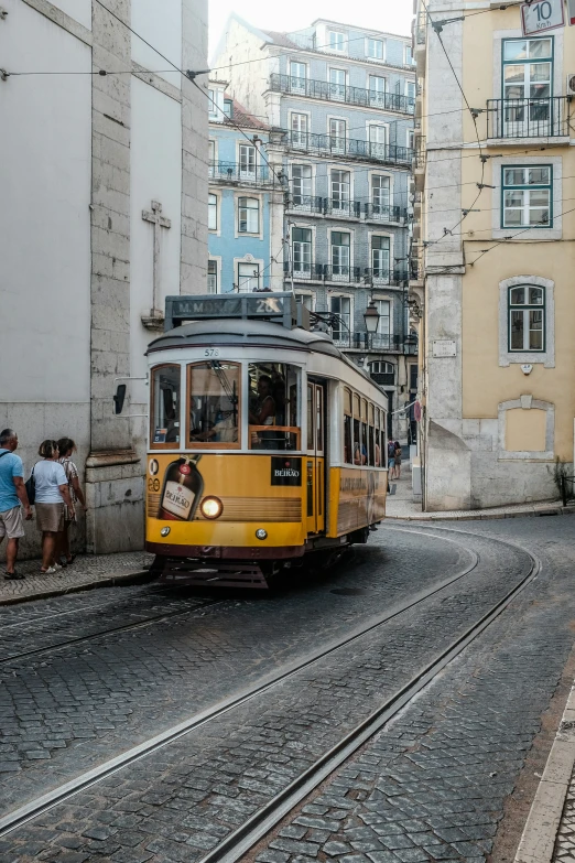 an old cable car makes its way through a narrow city