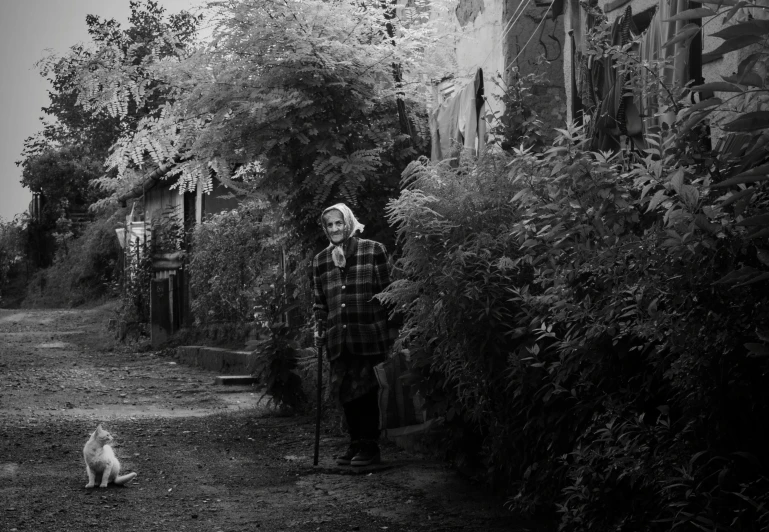 an elderly person walking next to a dog