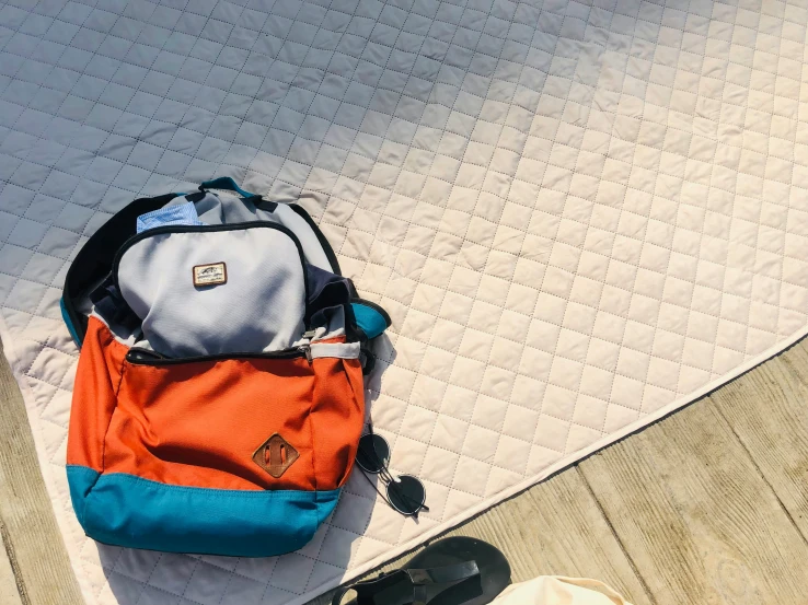 a backpack is laying on top of a mat