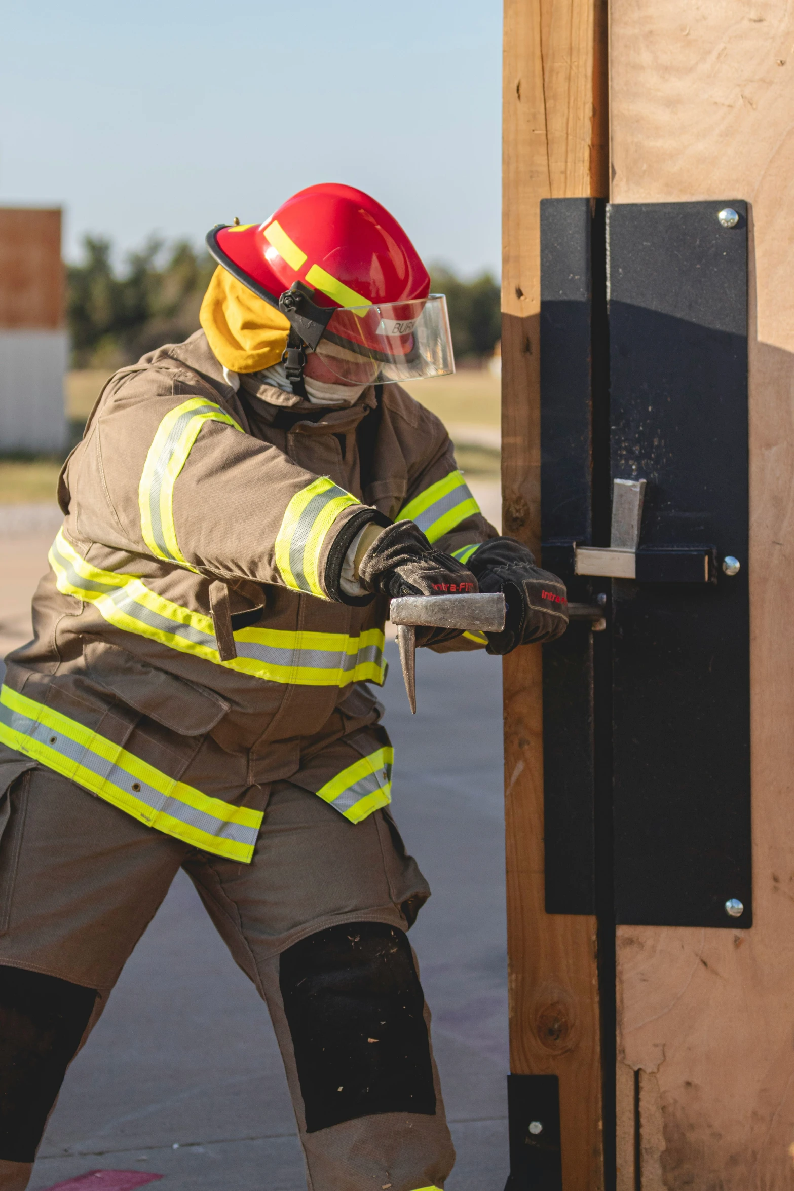 a fire fighter taking the fire out of an open fire truck door