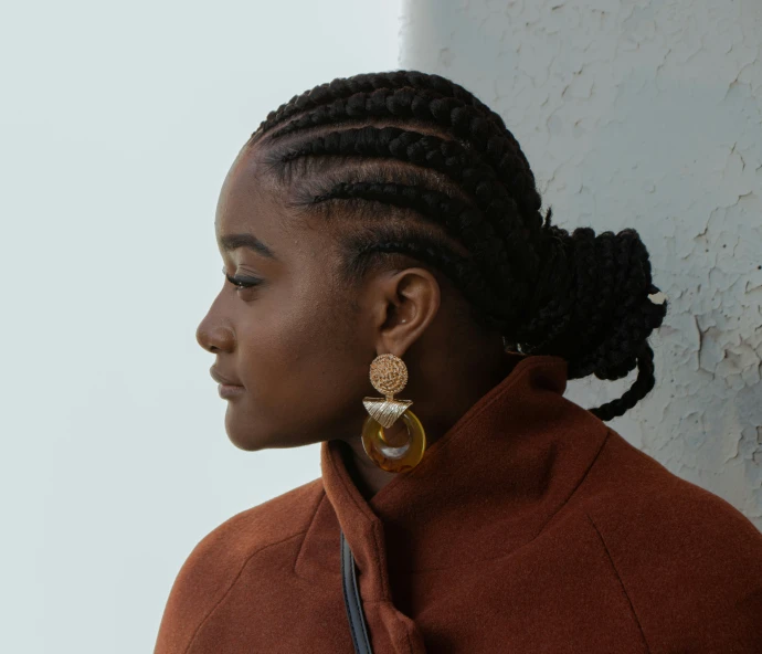 woman wearing long natural hair standing near wall