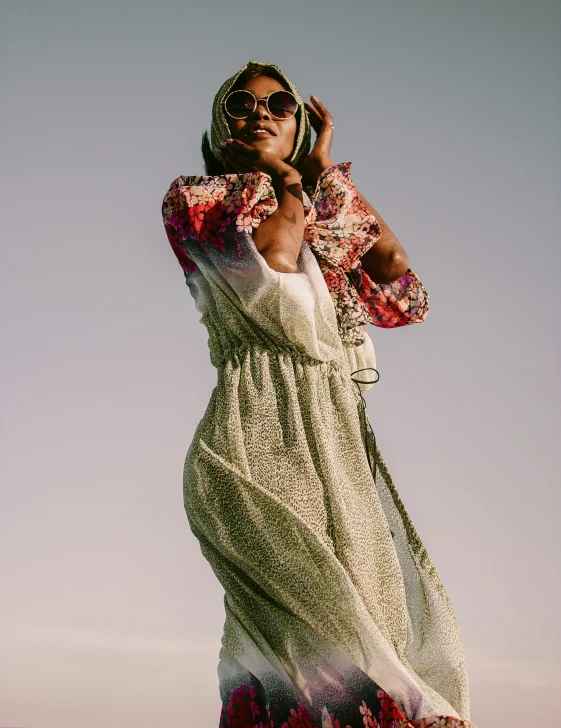 a woman is talking on her cell phone while posing in the sun